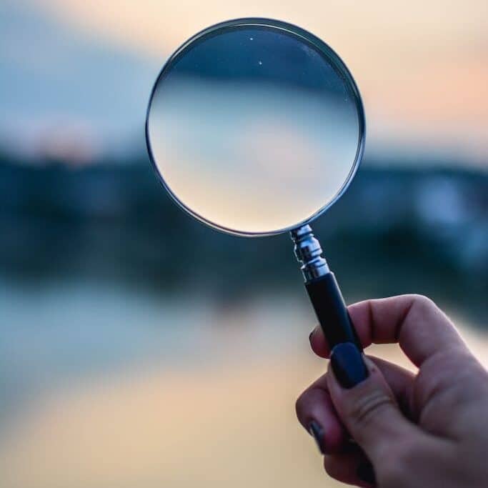 Selective Focus Photo of Magnifying Glass